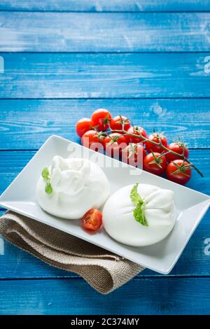 Burrata cheese with cherry peppers Stock Photo