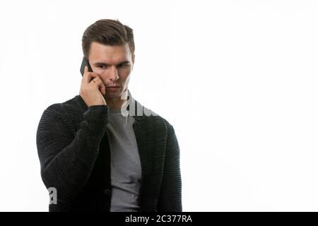 Portrait of a sad young man talking on the phone Stock Photo