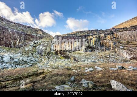 Old stone quarry with waterfall in Mourne Mountains near Slieve Donard mountain Stock Photo