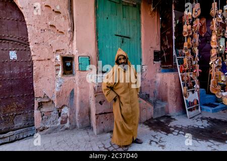 Marrakech, Morocco, Feb 2019: Old poor muslim man at traditional street market in Morocco. Moroccan old town medina with souk, shops Stock Photo