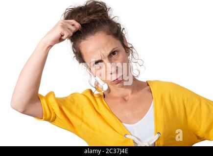 Confused beautiful girl scratches head, isolated on white background Stock Photo