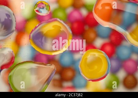 Colorfull water drops and chocolate sweets in top view Stock Photo