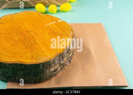 Wooden round board and craft paper on mint background. Stock Photo