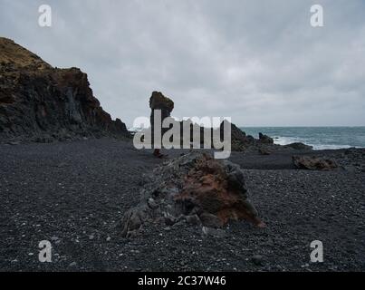 Colourful volcanic rocks and black pebbles on the beach in Iceland Stock Photo