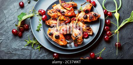 Fried chicken wings in spicy cherry sauce.Grilled chicken, fast food. Stock Photo