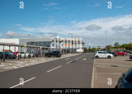 Irvine, Scotland, UK - June 15, 2020: Sainsbury’s Branded supermarkets still quiet with half empty carparks in Irvine during covid-19 lockdown. Stock Photo