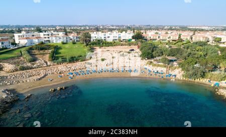 Aerial bird's eye view of Sirena beach in Protaras, Paralimni, Famagusta, Cyprus. The famous Sirina bay tourist attraction with sunbeds, golden sand, Stock Photo