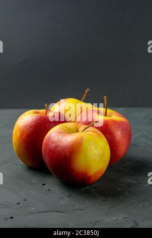 Apples on black stone table background. Front views Stock Photo