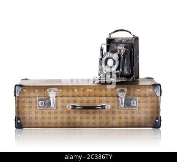 The suitcase with old camera isolated on white background Stock Photo