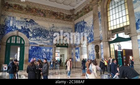 Porto, Portugal, circa 2018: Traditional Portuguese painted tiles azulejos depicting Portuguese history inside the Porto Train Station Stock Photo