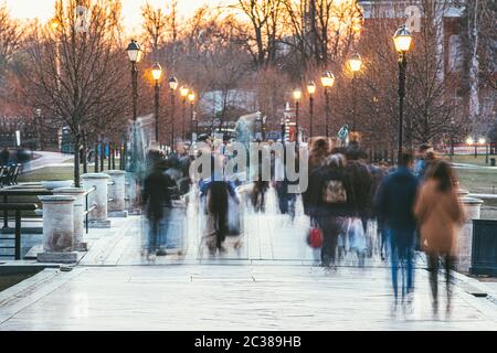 A crowd of blurred people walking in the autumn Park Stock Photo