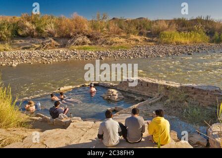 Visitors at Hot Springs water pool on the edge of Rio Grande, Chihuahuan Desert in Big Bend National Park, Texas, USA Stock Photo
