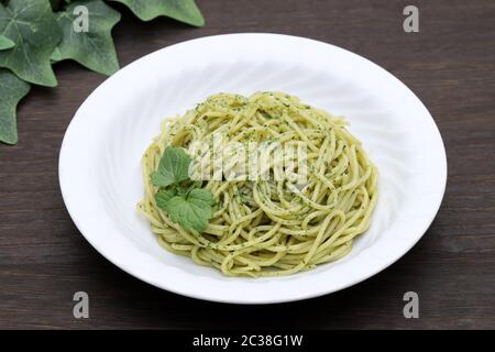 Pasta spaghetti with basil, cream and cheese on white table Stock Photo