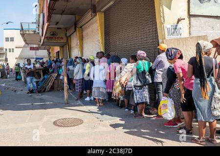 People queue in Durban during the Corona Virus Pandemic Stock Photo