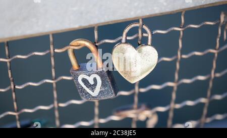 Two old rusty padlocks with heart on the bridge, 16:9 panoramic format Stock Photo