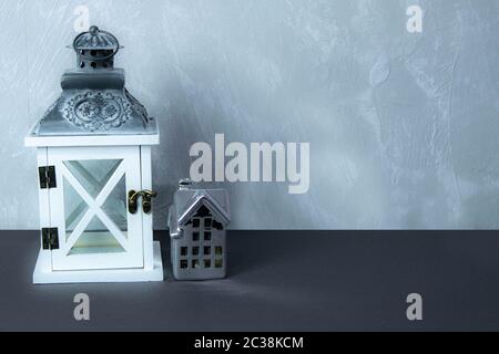 Hand light for candles and craft ceramic house on the grey background Stock Photo