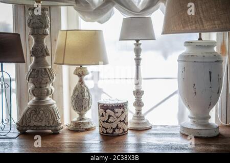 old table lamp standing on the table, carved legs, lots of lamps, a vintage lamp Stock Photo