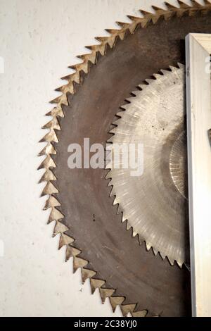 several saw blades for a circular saw hanging on a wall Stock Photo