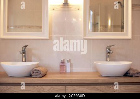 Modern bathroom with two sinks new luxury design with two mirrors close-up Stock Photo