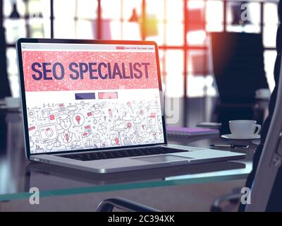 Modern Workplace with Laptop Showing Landing Page in Doodle Design Style with Text SEO - Search Engine Optimization - Specialist. Toned Image with Sel Stock Photo