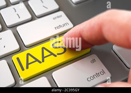 IAAS Concept - Computer Keyboard with Key. Computer User Presses IAAS Yellow Keypad. Hand Finger Press IAAS Keypad. Man Finger Pushing IAAS Yellow Key Stock Photo