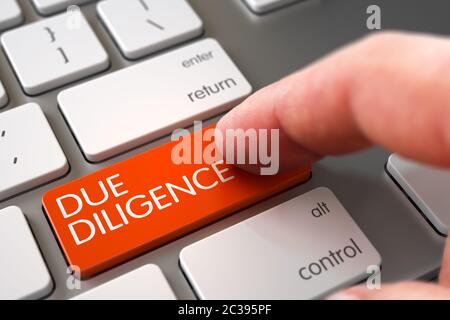 Finger Pushing Due Diligence Key on Aluminum Keyboard. Computer User Presses Due Diligence Orange Button. Finger Pressing a Aluminum Keyboard Keypad w Stock Photo