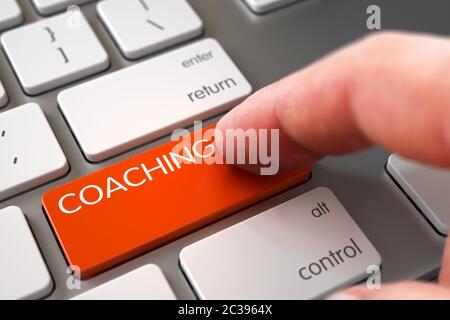 Finger Pushing Coaching Key on Modern Keyboard. Coaching Concept - Slim Aluminum Keyboard with Key. Finger Pressing a Modern Laptop Keyboard Button wi Stock Photo