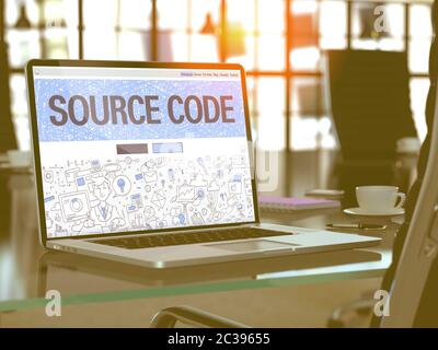 Source Code - Closeup Landing Page in Doodle Design Style on Laptop Screen. On Background of Comfortable Working Place in Modern Office. Toned, Blurre Stock Photo