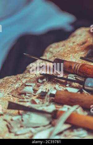 Wood sculptor tools on a table in workshop Stock Photo