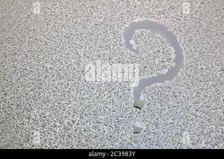 Question mark. The inscription on a wet metal surface. Stock Photo