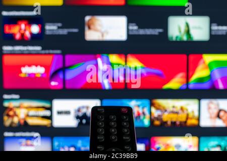 Video on demand screen with remote control in the foreground Stock Photo