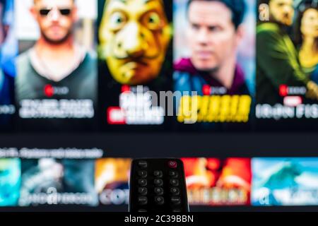 Video on demand screen with remote control in the foreground Stock Photo