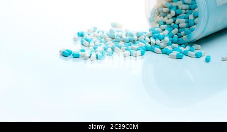 Blue-white antibiotic capsule pill and capsule pills bottle. Antibiotic drug resistance. Pharmaceutics concept. Pharmaceutical industry. Pharmacy prod Stock Photo