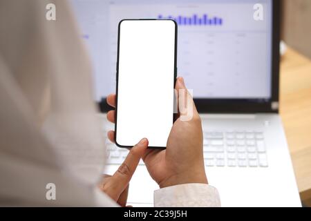Close up image of smart phone mockup, woman holding phone with white screen template Stock Photo