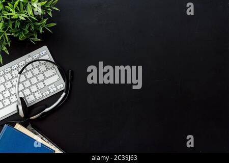 Education online school concept. Books, computer and headphones on black table top view frame space for text Stock Photo