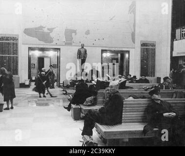 View into the waiting hall of the Vnukovo Airport in Moscow. In the background at the wall is a statue of Stalin. Stock Photo