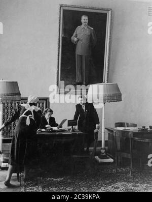 View of the desk of the floor manager, above which hangs a huge Stalin painting. Two years after his death and one year before the de-Stalinization he is still omnipresent. Stock Photo