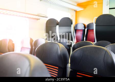 Empty seats in modern train at sunny day Stock Photo