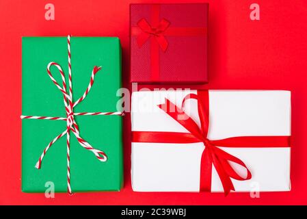 Happy New Year and Christmas 2020 day, top view Xmas multi color gift boxes on red background with copy space for your text Stock Photo
