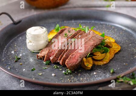 Beef steak with potato chips and little salad Stock Photo