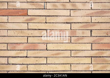 Background from a wall of beige clinker bricks Stock Photo