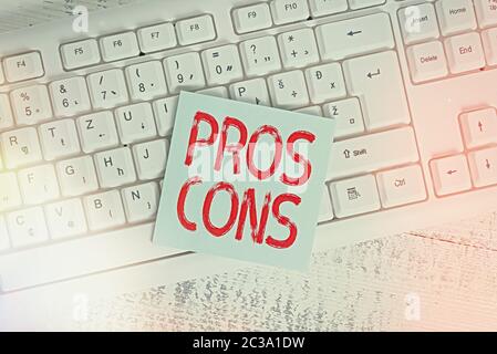 Conceptual hand writing showing Pros Cons. Concept meaning advantages and disadvantages observed while examining a product Keyboard office supplies re Stock Photo