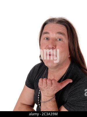 A image of a middle age indigenous man standing and blowing a kiss, isolated for white background Stock Photo