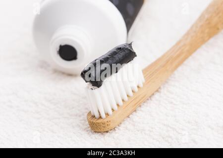 Toothbrush with black charcoal toothpaste Stock Photo