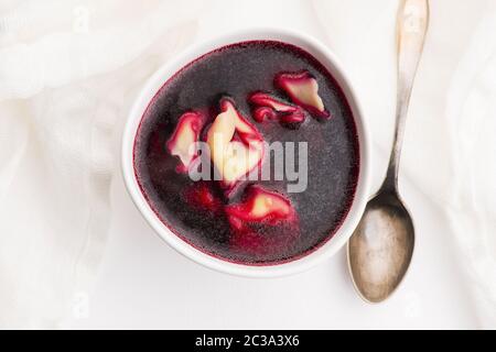 Christmas beetroot soup, borscht with small dumplings with mushroom filling Stock Photo