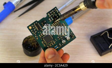 Workshop on repair of household appliances, electronics and processors. soldering Board soldering iron, re-soldering chips, replacing transistors, thy Stock Photo