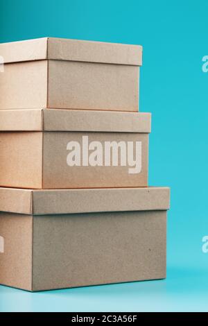Postal cardboard boxes on a blue background close-up. Stock Photo
