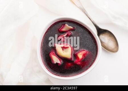 Christmas beetroot soup, borscht with small dumplings with mushroom filling Stock Photo