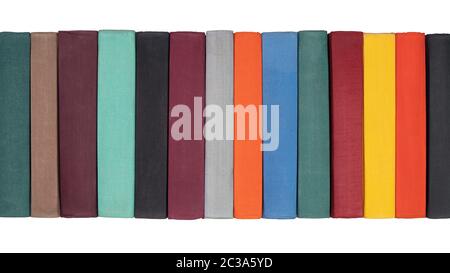 Stack of old hardcover books on bookshelf. Close-up view of multicolored vintage hardback books Stock Photo