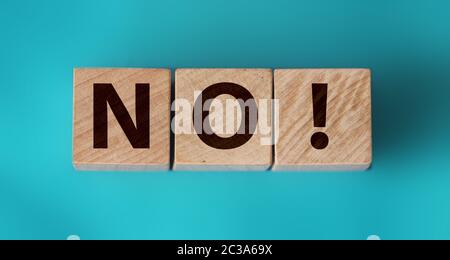 Wooden cubes with text no on a blue background. Negative answer concept. No risk, no violence or no discrimination concept Stock Photo